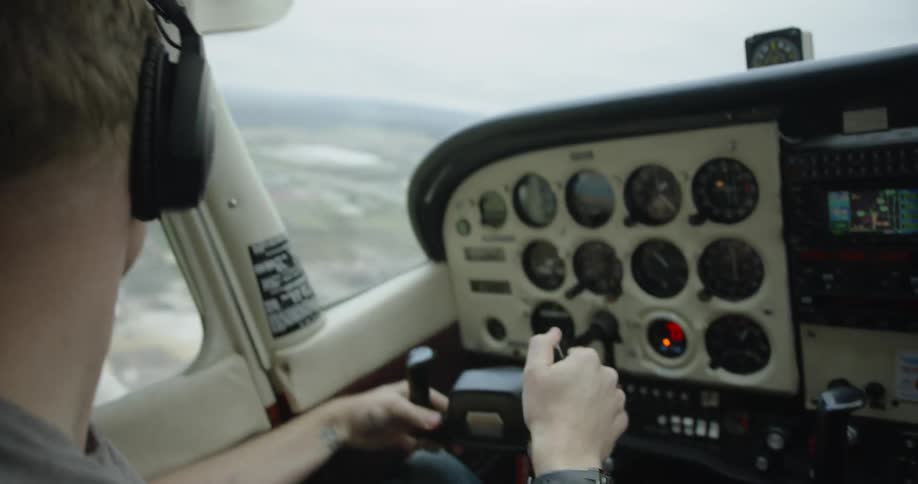Pilot Flying Cessna Plane Above City