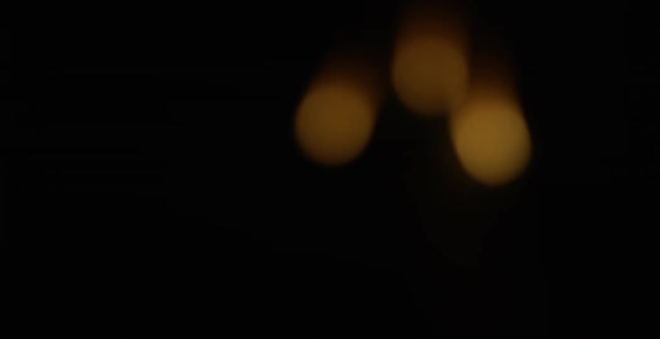 Blurry fireworks explode and fade into darkness