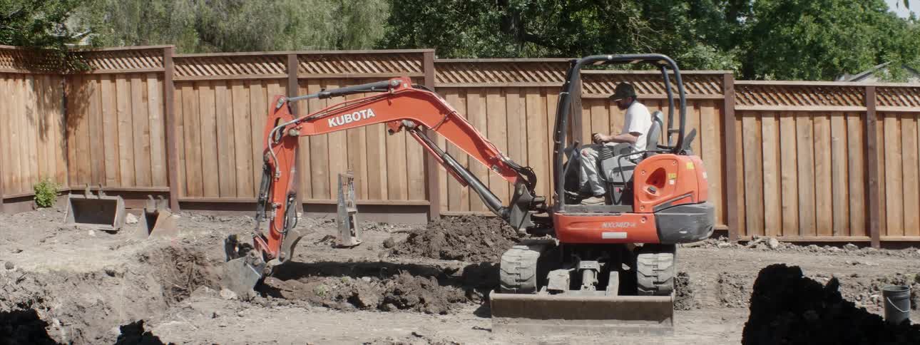 An excavator digs up dirt at a construction site