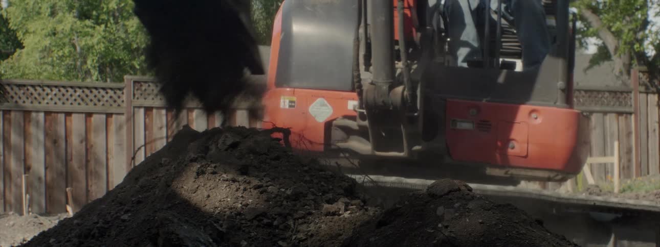 An excavator digs up dirt at a construction site