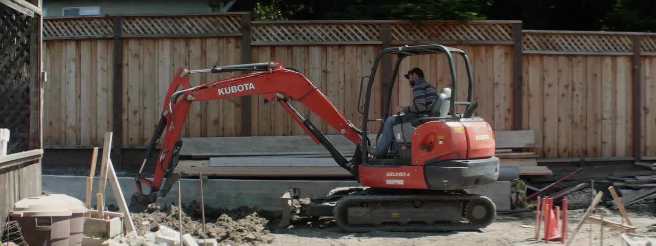An excavator digs up dirt at a construction site