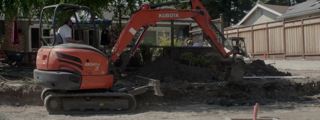 An excavator digs up dirt at a construction site