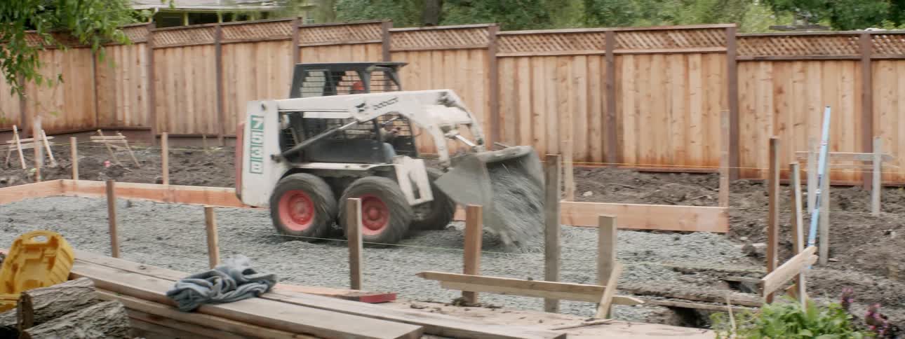 The bulldozer winds up to spill rocks all over