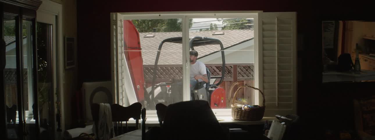 An excavator digs up dirt in a backyard