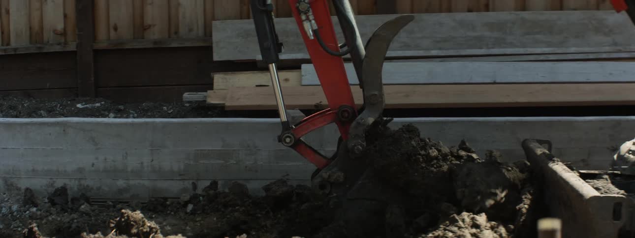 An excavator digs up dirt at a construction site
