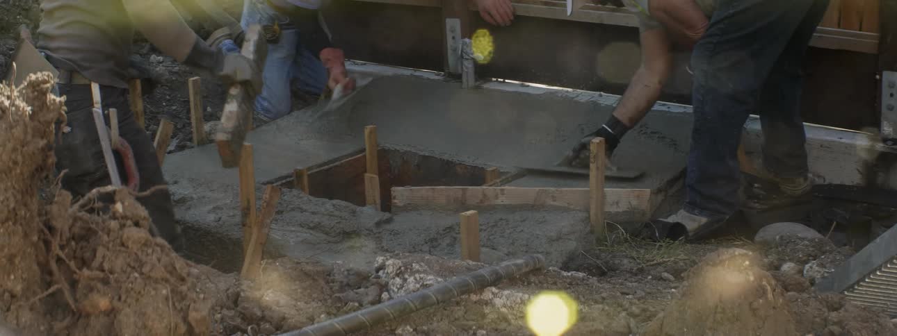 The workers are smoothing out concrete