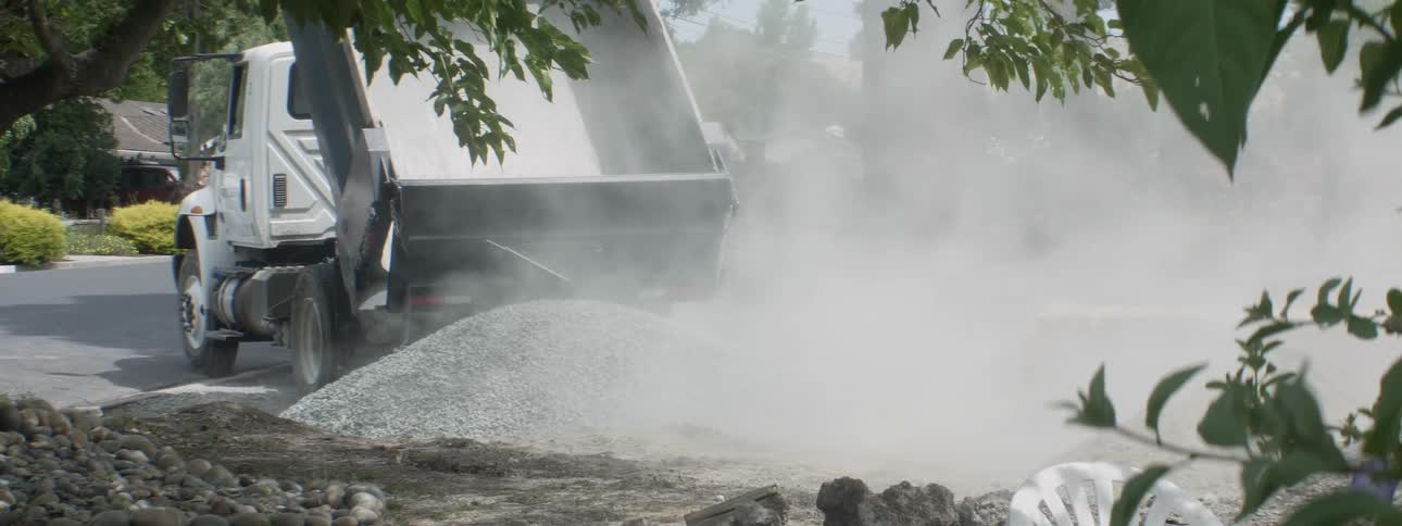 Gravel is poured from a dump truck