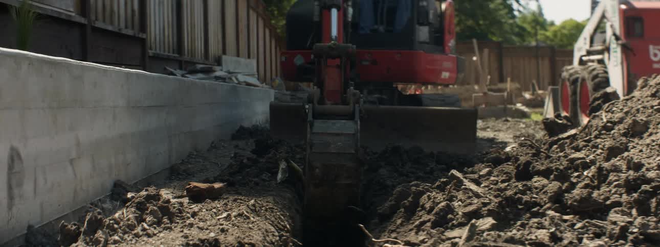An excavator digs up dirt at a construction site