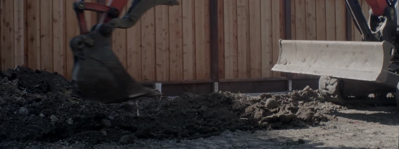 A construction vehicle is used to lift and move dirt