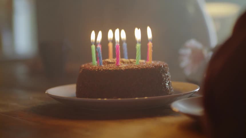 Candles are blown out on a birthday cake