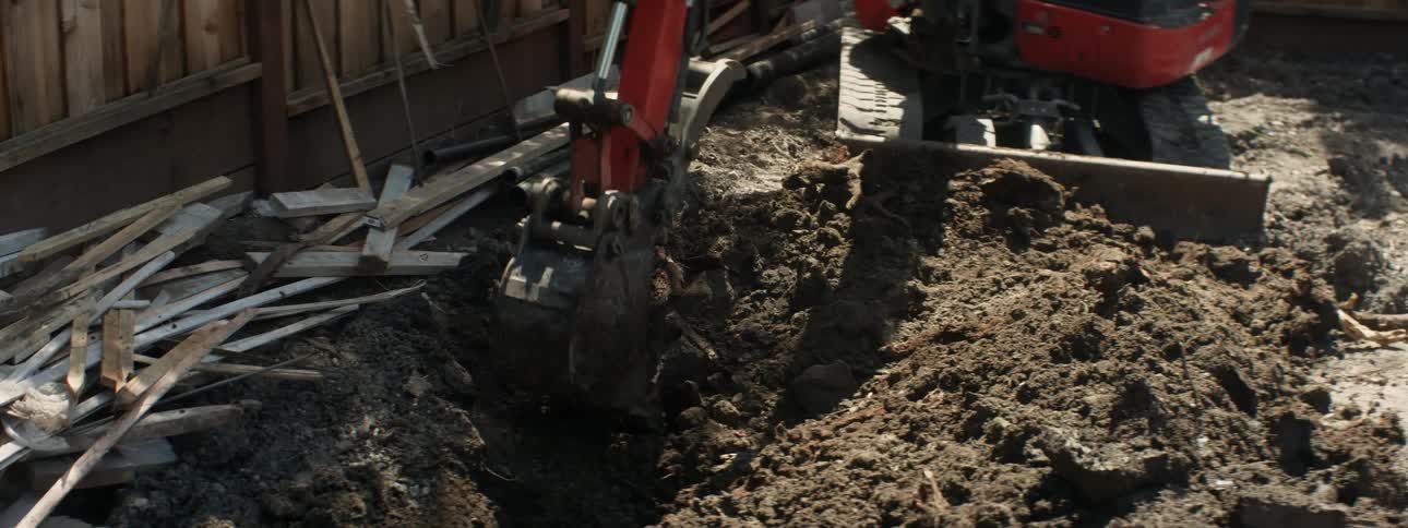 An excavator digs up dirt at a construction site