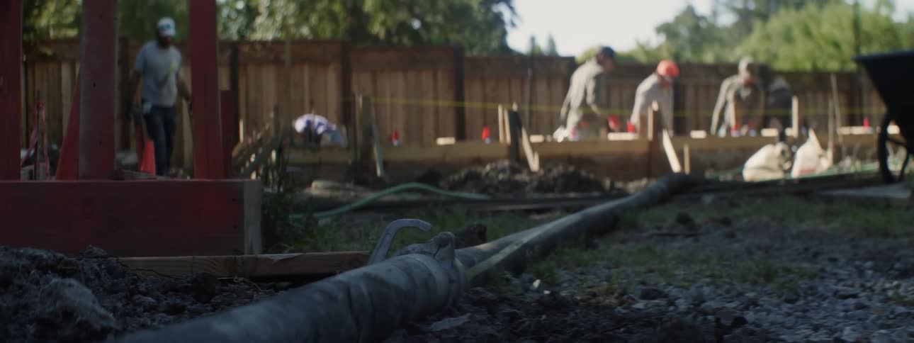 The construction workers are very busy in the yard