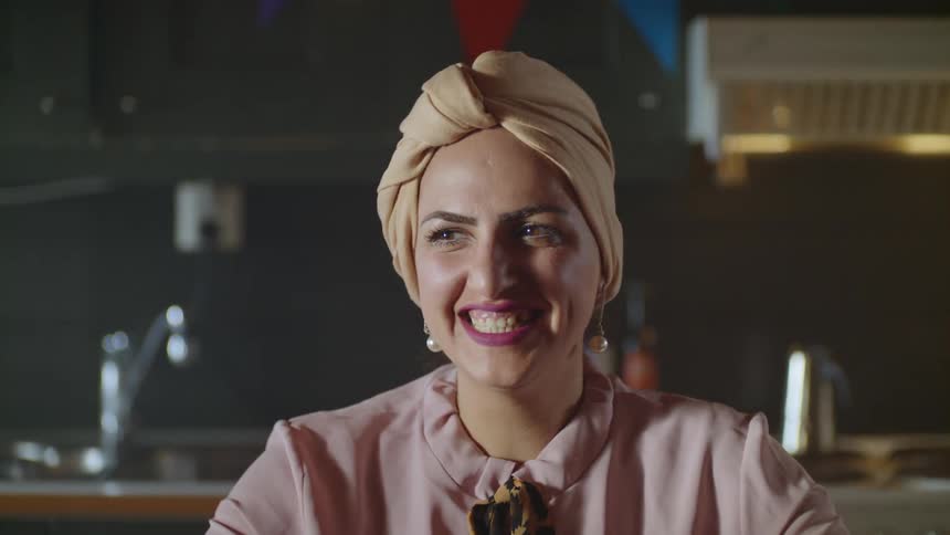 A woman laughs and smiles at the table