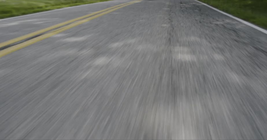 The road is moving by fast on a sunny day