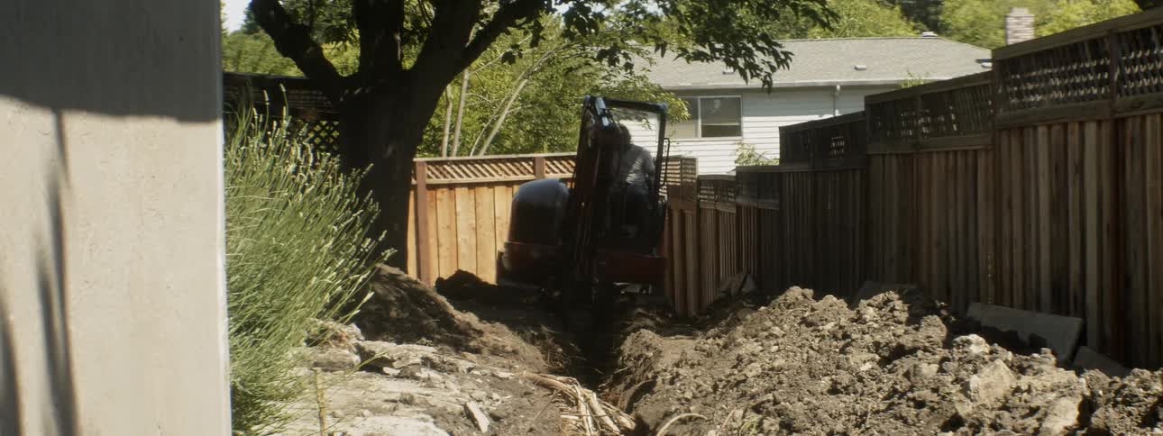 An excavator digs up dirt at a construction site
