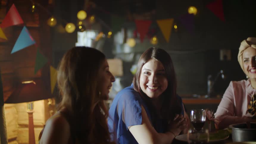 Women smile and laugh at a party