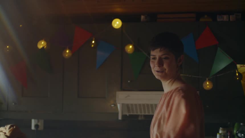 The woman laughs and talks at the party