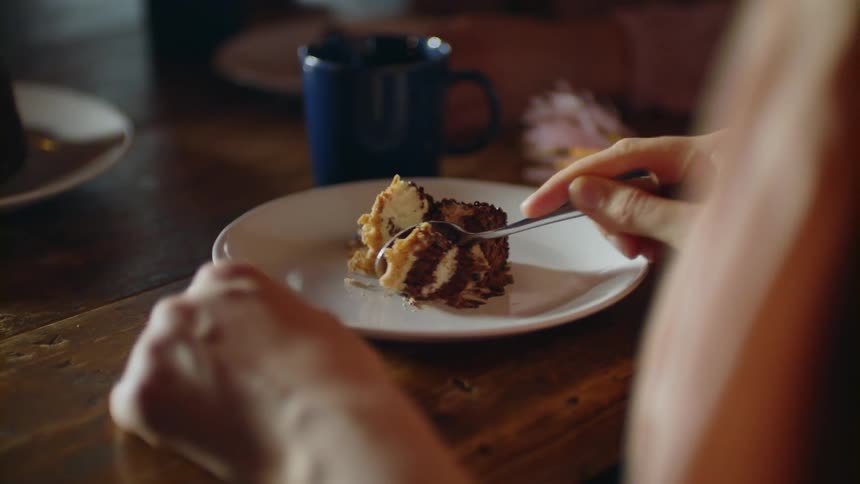 A woman eats a piece of cake
