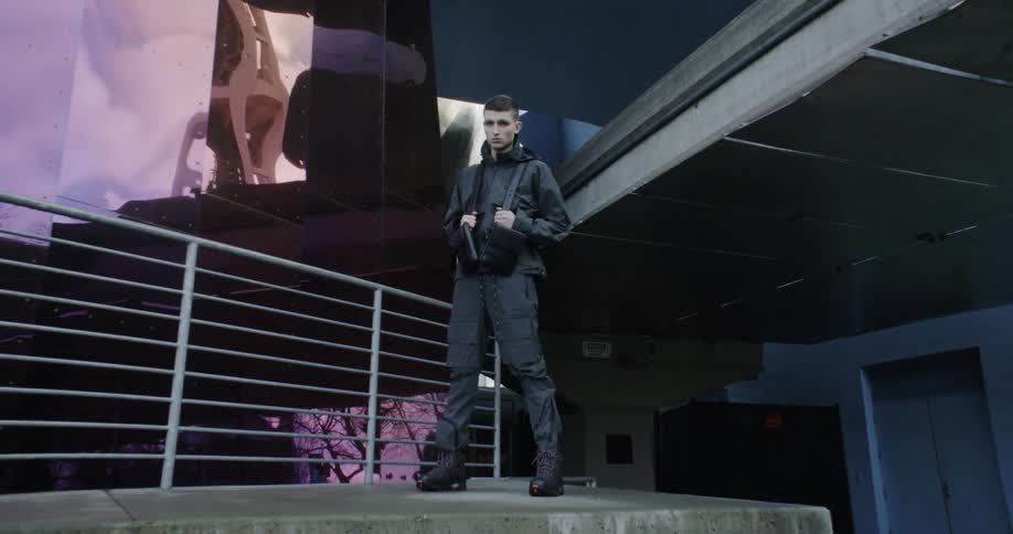 A man poses in front of a building