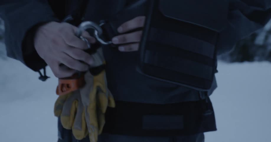 A man removes his gloves from his latch