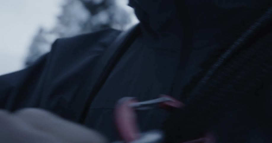 A man attaches a harness to his jacket