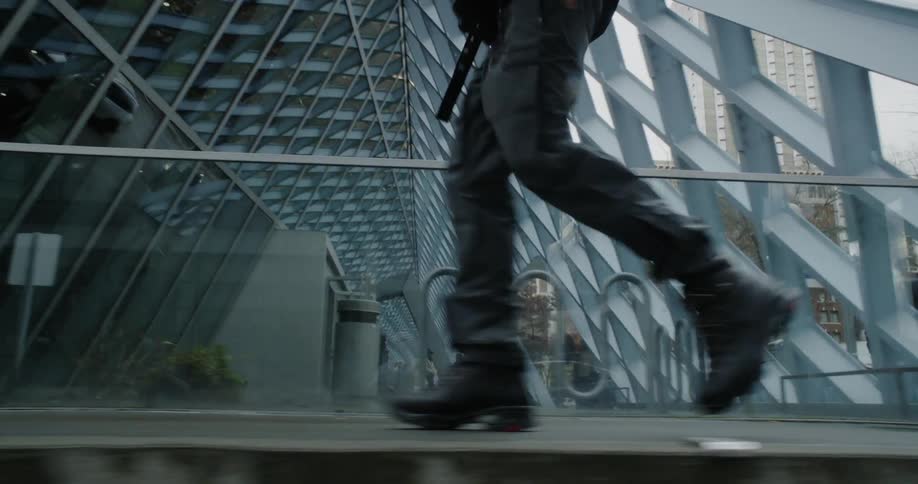 A man walks in front of a building