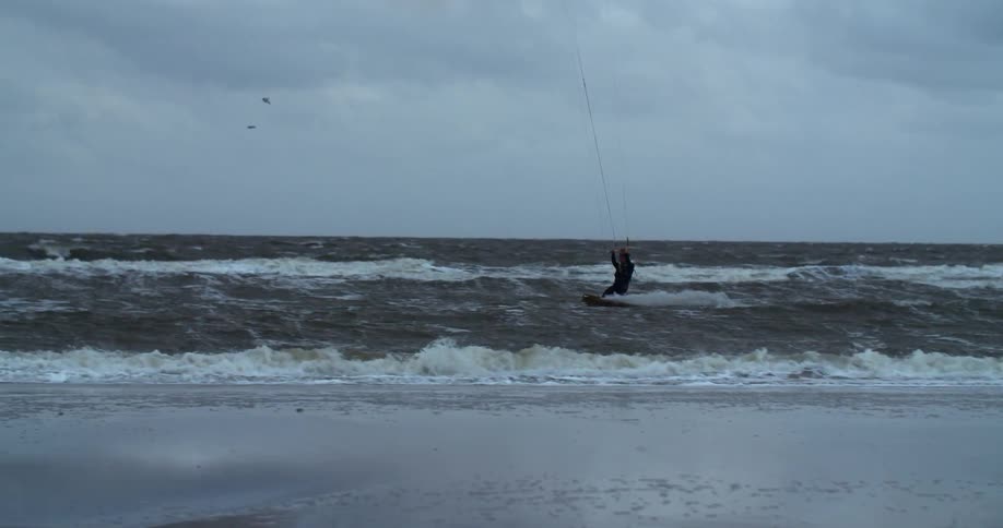 The man is surfing in the very rough waves