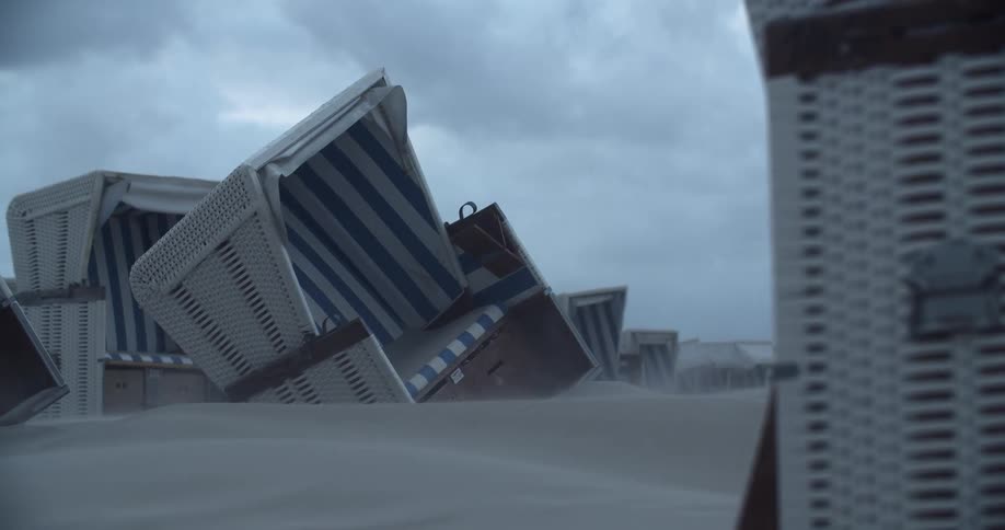 The tents on the beach are fallen over