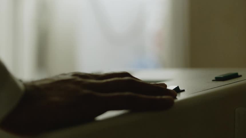 A man's hand flips a switch