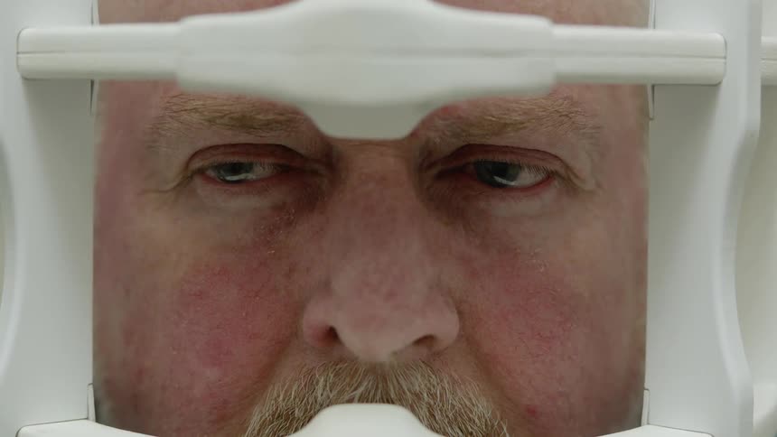 The man closes his eyes in the imagine machine