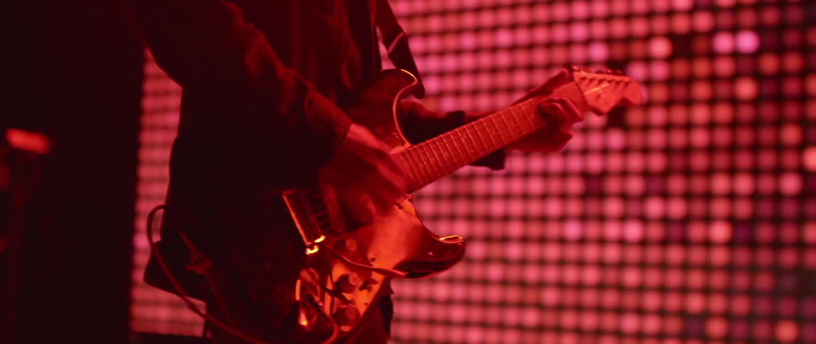 A man plays guitar on a stage