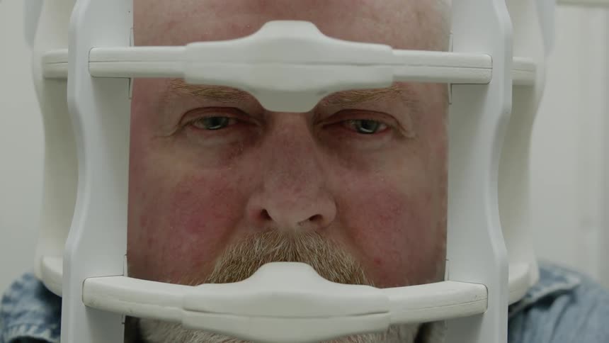 A man is in a medical device being examined