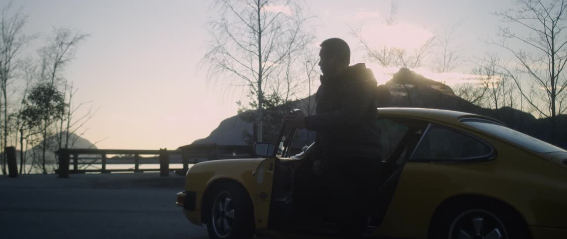 Man Driving Classic Yellow Sports Car