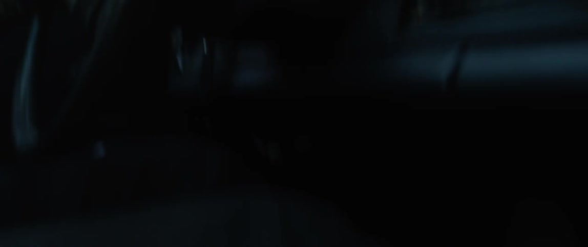 Person shifts the shifter of a car and holds onto the steering wheel