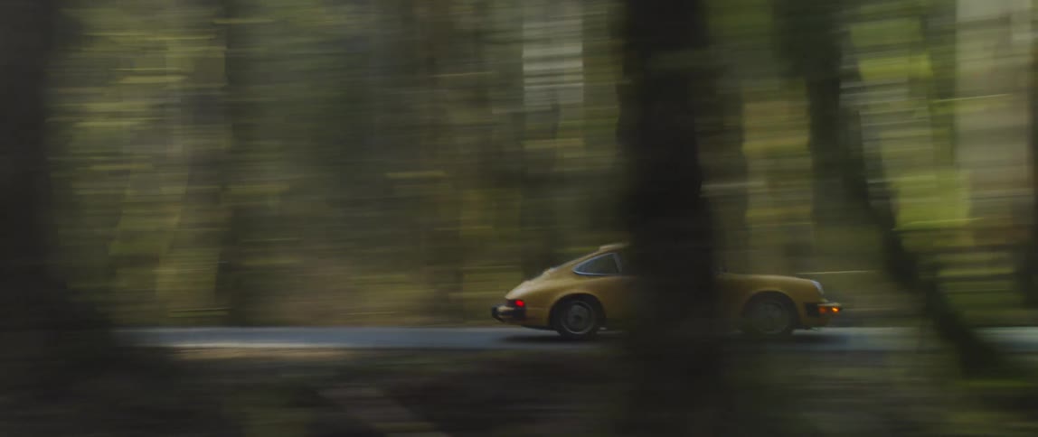 Man Driving Classic Yellow Sports Car