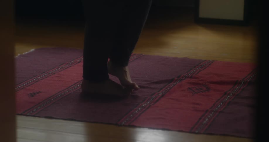 The man walks over the small carpet