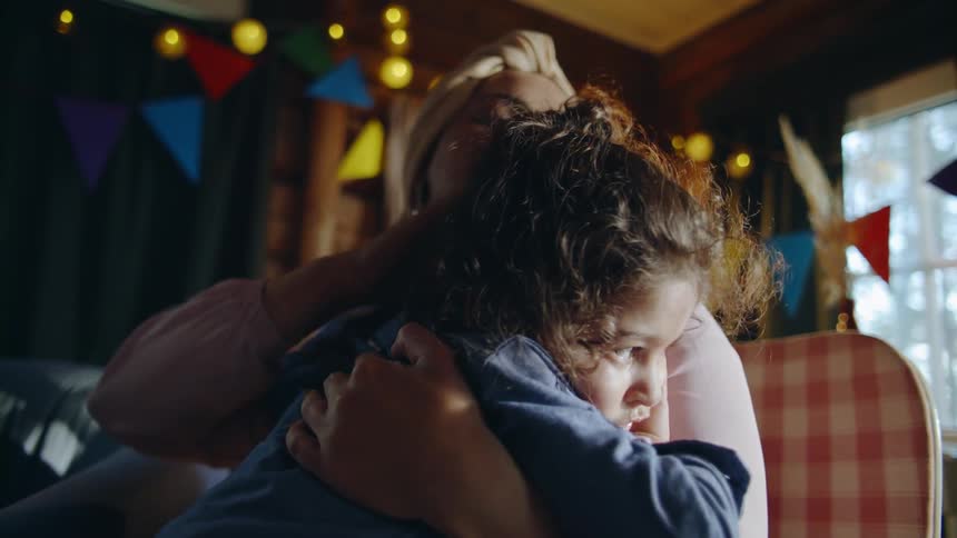 A mother comforts a daughter at a party