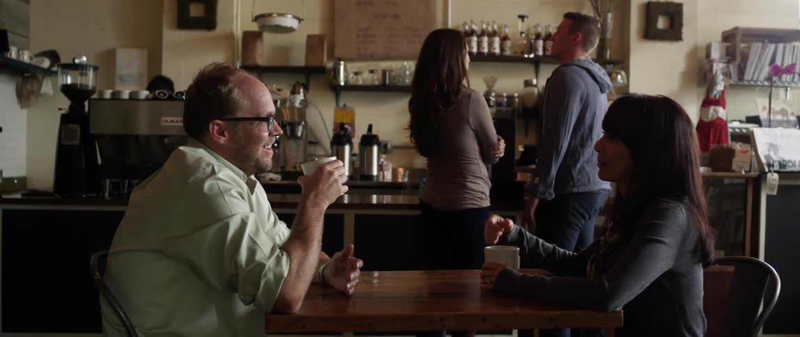 A coffee shop with a couple ordering, and a couple sitting down for a drink and chat