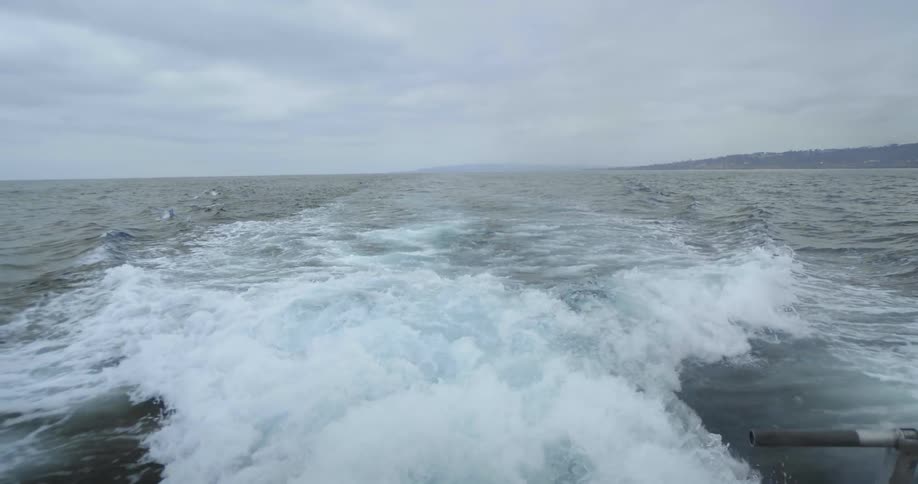 A boat floats on an ocean