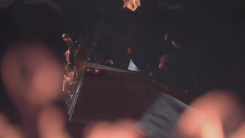 A burning book falls