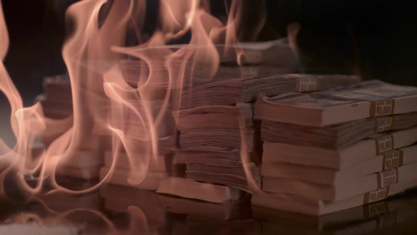 A pile of cash is on fire