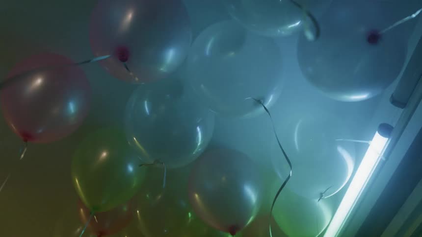 Lights flash at a party with balloons
