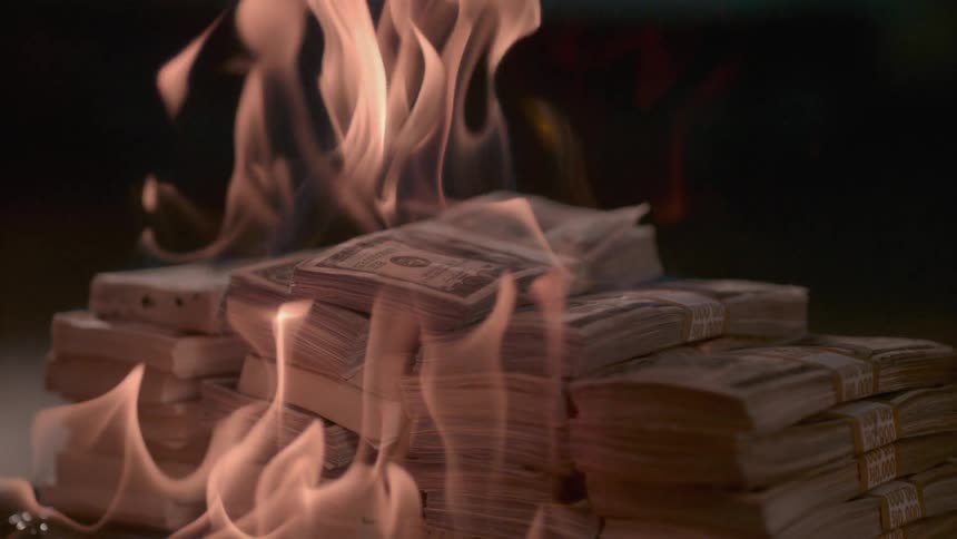 A pile of cash is on fire