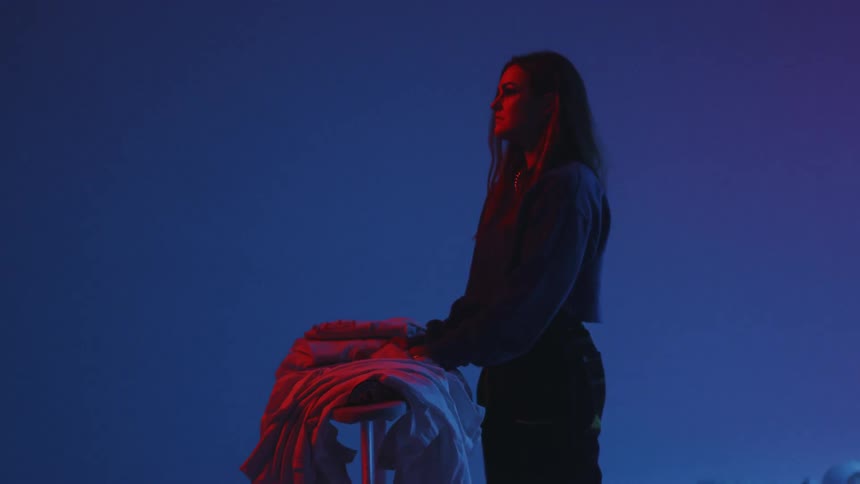 Man Playing On Pile Of Clothes In Studio