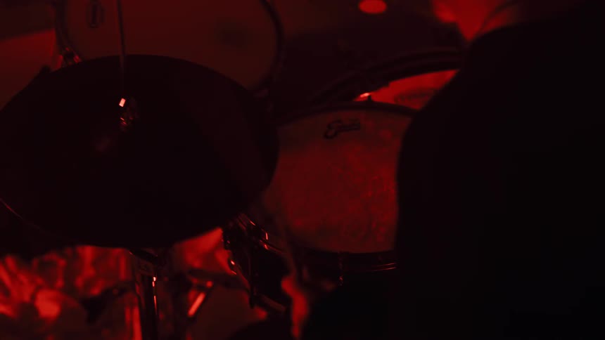 Lights flash while a man plays drums