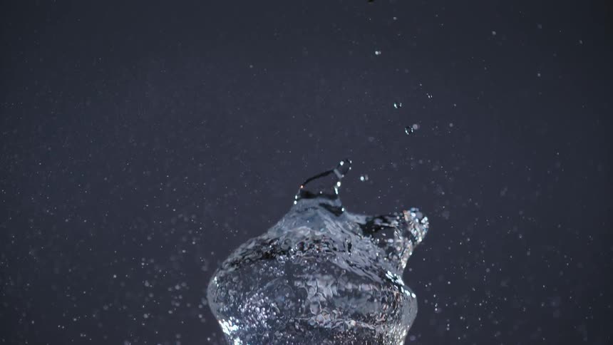 A water balloon pops in midair