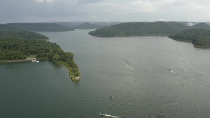 Two boats cruise on a large river