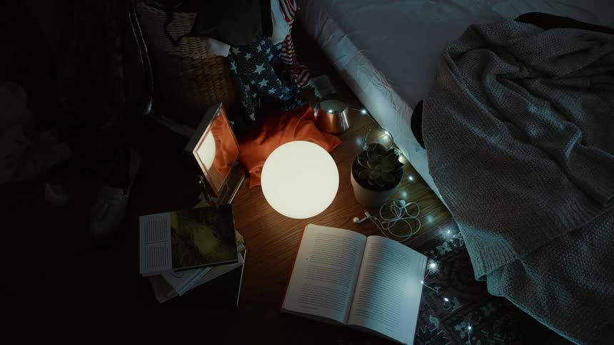 The ground is covered with items such as a glowing org, books and pictures