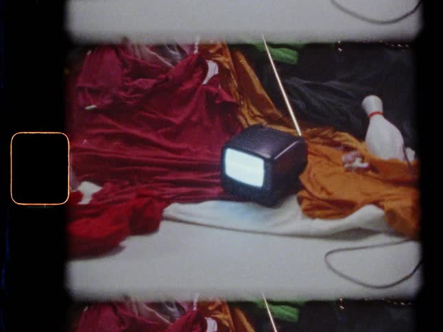 A television sits in a pile of random objects