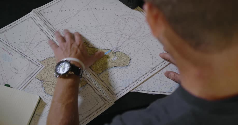 A man looks at a map on a desk